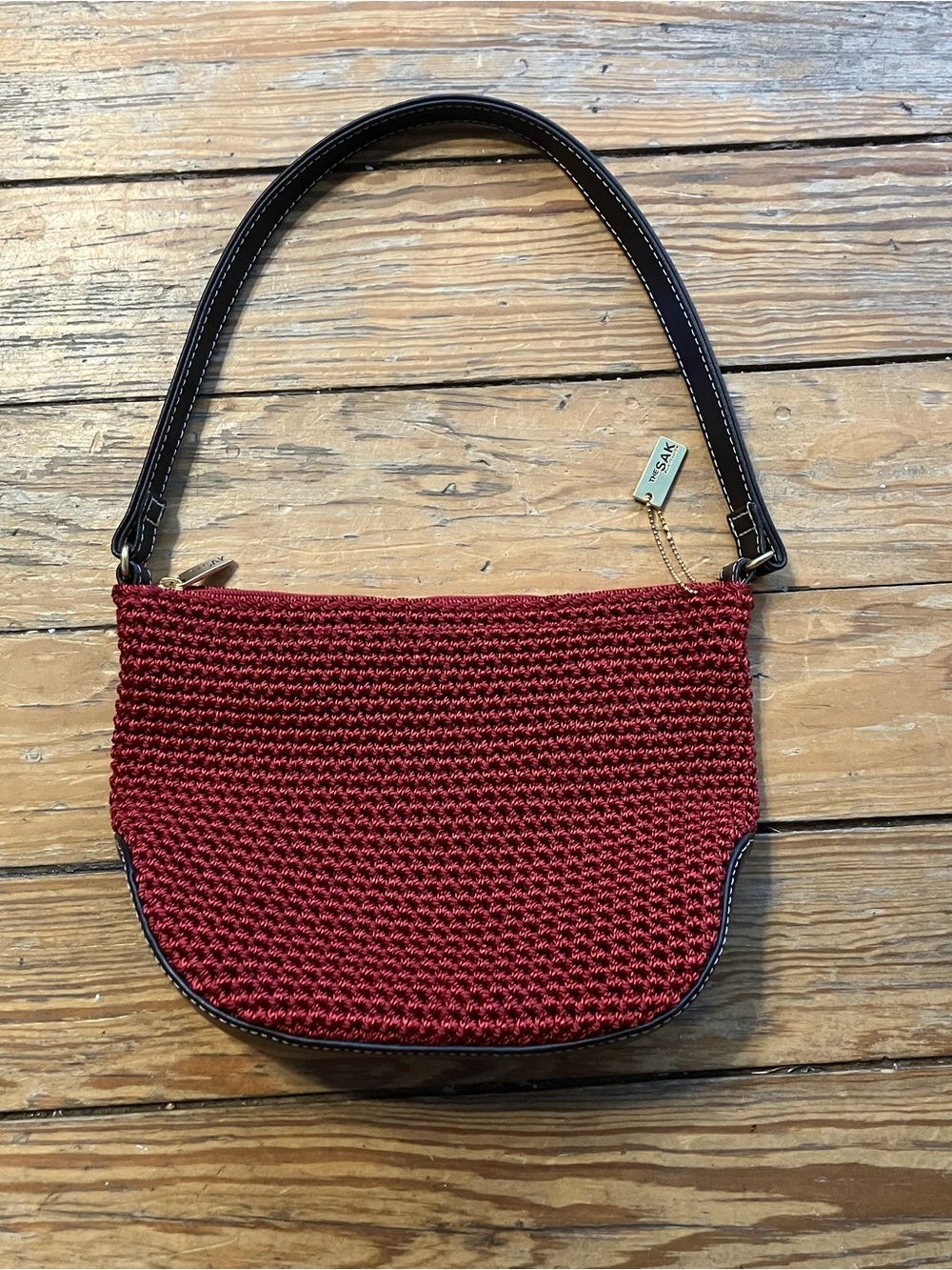 The Sak red woven mini handbag, dark brown trim and handle